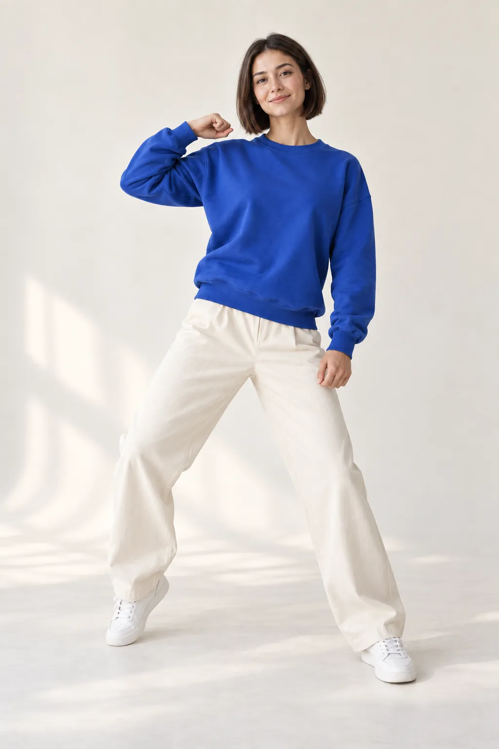 Motion transfer illustration: the same woman in a blue sweatshirt repeating a dance pose